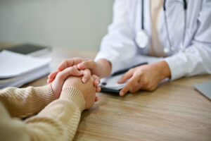 medical provider touching patient hands