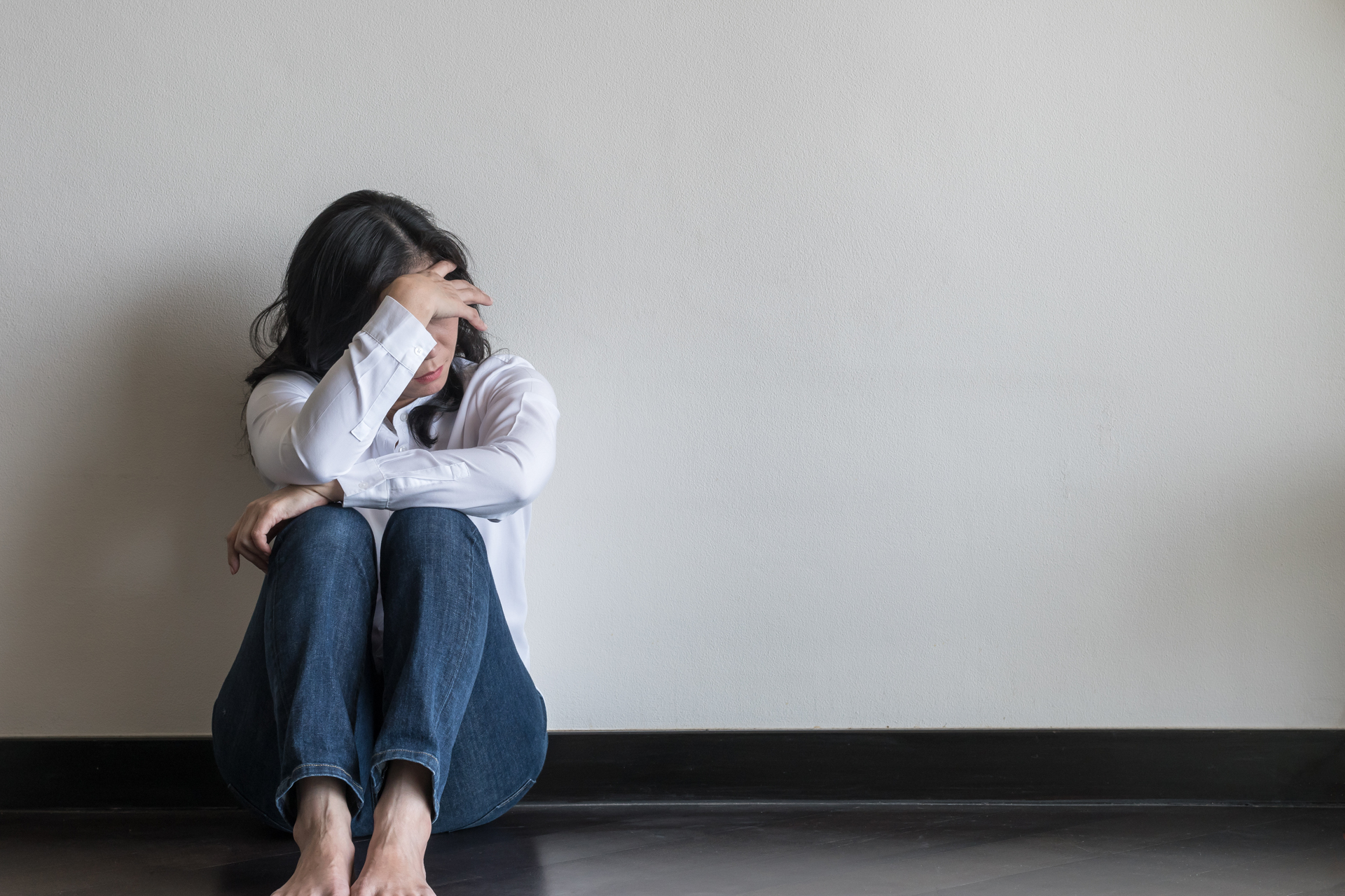 sad woman sitting on floor