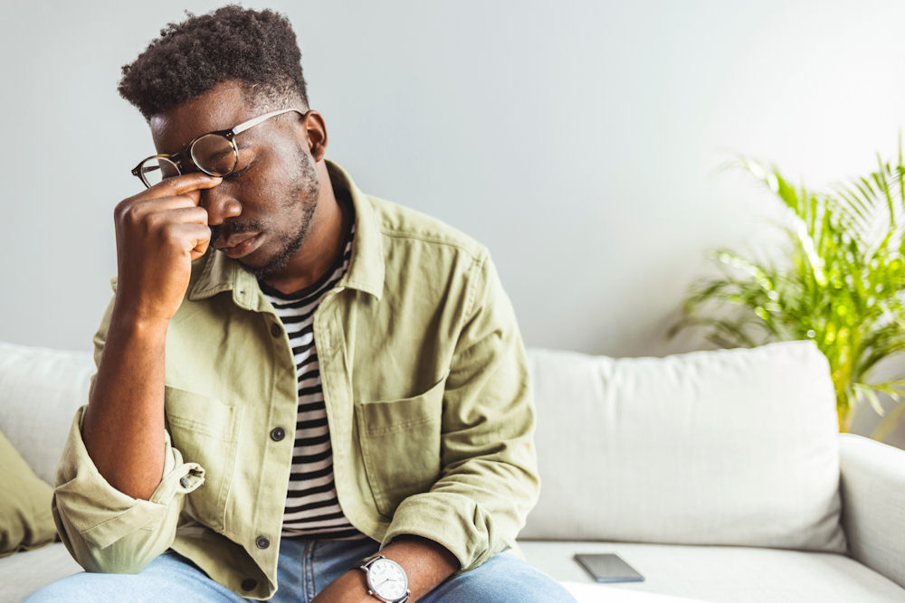 depressed man touching face