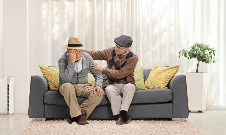 two seniors sitting on a couch