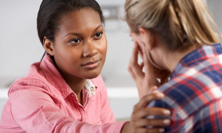 woman consoling upset woman