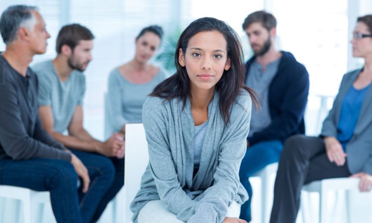 woman sitting in front of support group for opioid addiction